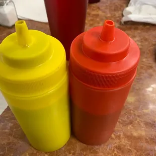 NOT ketchup and mustard. They&apos;re some kind of hot sauces. Very good but the red one is super spicy.