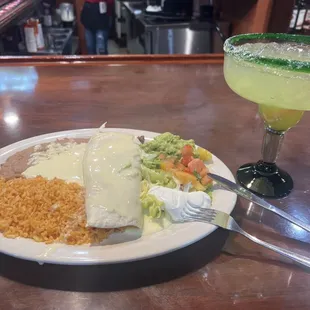 a plate of mexican food and a margarita