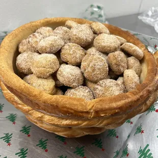 a bowl of sugar coated doughnuts