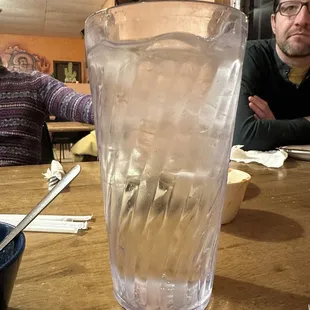 a man sitting at a table with a glass of water