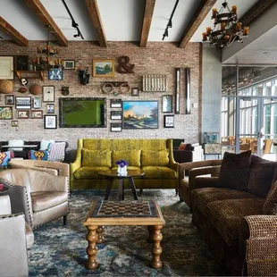 a living room with exposed brick walls
