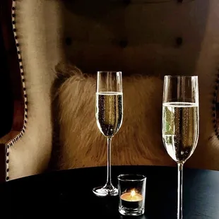 two glasses of champagne on a table