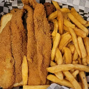 a basket of fried fish and french fries
