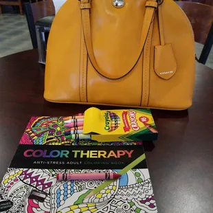 a handbag and coloring books
