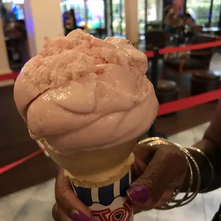 a woman holding a cone of ice cream