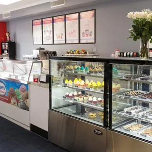 a display case of cakes and pastries