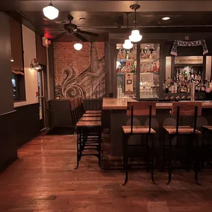 a dimly lit bar with chairs