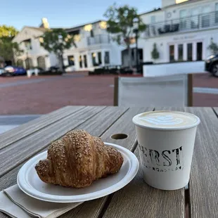 a croissant and a cup of coffee