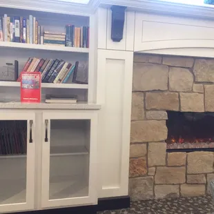 Bookshelves on the one side. Grab a book and drink your coffee or other beverage. Leave and Take Lending Library type set-up.