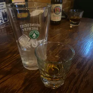 a glass of whiskey and a bottle of beer
