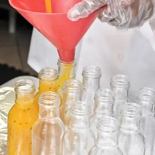 a person pouring something into a funnel