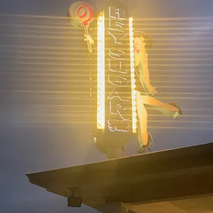  a neon sign for a candy shop