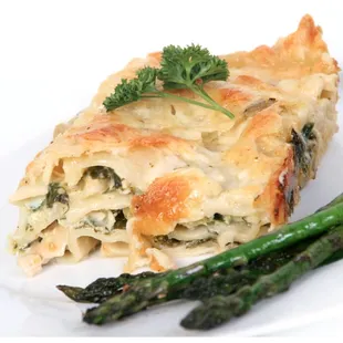 a slice of lasagna with asparagus