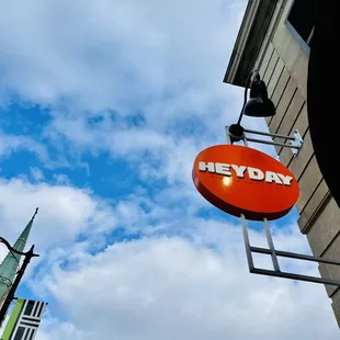 a sign for heyday on a building