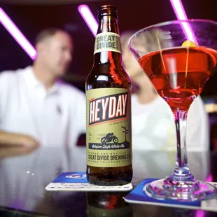 a man behind a bar with a drink