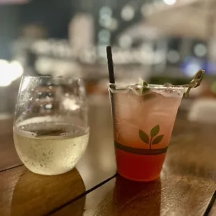 a glass of wine and a drink on a table