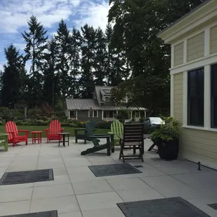 a patio with chairs and tables