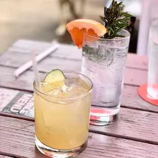 two cocktails on a wooden table