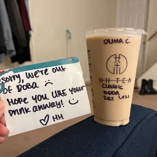 a hand holding a cup of coffee