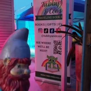 a gnome statue in front of a book store