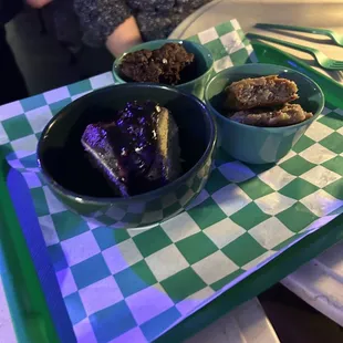 two bowls of food on a tray