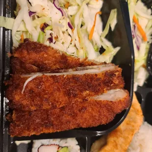 Cabbage and carrot slaw. No steamed veggies under the katsu.