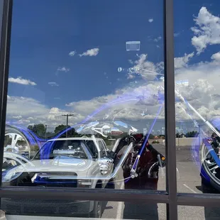 a reflection of a car and a motorcycle