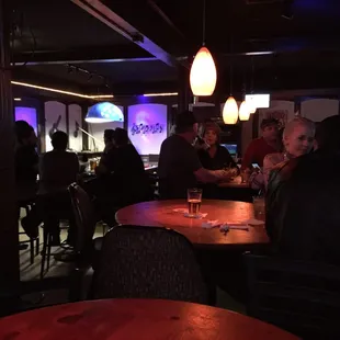a group of people sitting at a bar