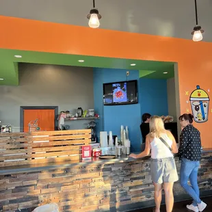a group of people standing at a counter