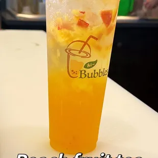 a peach fruit tea in a plastic cup