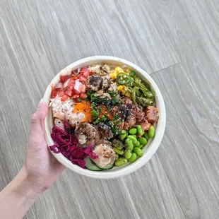 a person holding a bowl of food