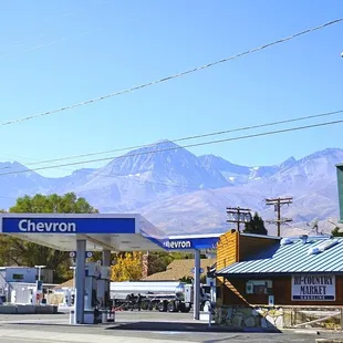 a gas station with mountains in the background