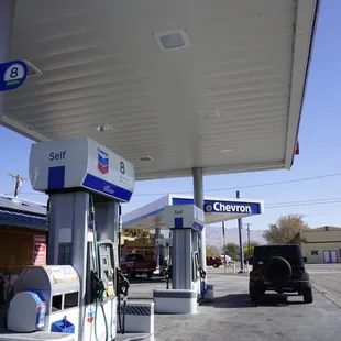 a gas station with a car at the pump