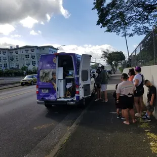 a group of people getting on a bus