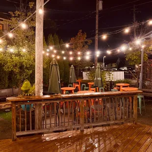 a patio with tables and umbrellas