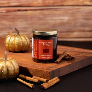 a pumpkin and cinnamon stick on a cutting board