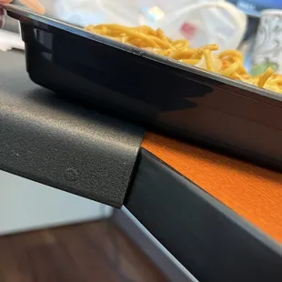 a person holding a tray of food