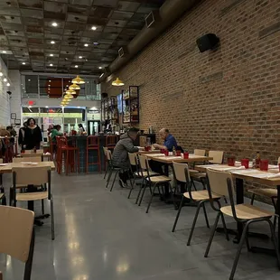 people sitting at tables in a restaurant