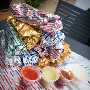 a stack of foil wrappers and condiments