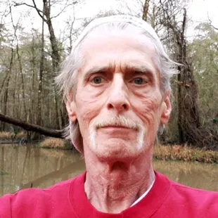a man standing in front of a river