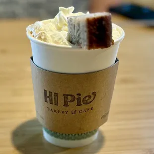 Manic Monkey. Hot drink of espresso, maple butter, milk, whip and Poi Banana Bread garnish. ($7)