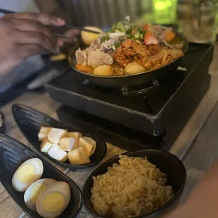 Kimchi hotpot soup, side of instant noodle, fish tofu and eggs