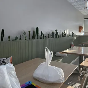 the interior of a restaurant with tables and chairs