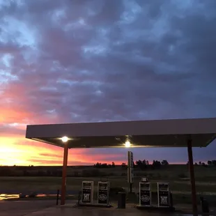 a gas station at sunset