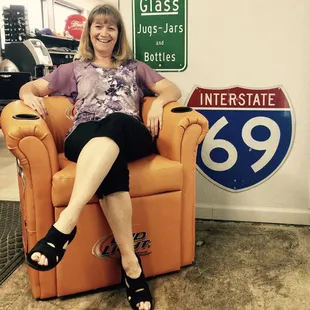 a woman sitting in an orange recliner