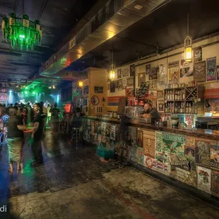 the inside of a bar with a lot of people