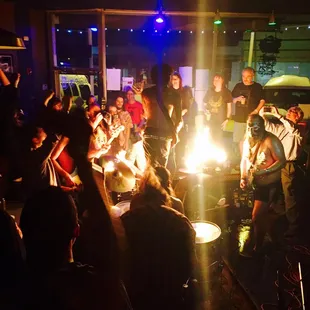 a group of people sitting around a fire pit