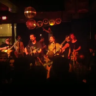 a band performing in a dark room