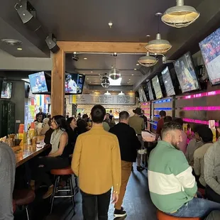 a large group of people sitting at a bar