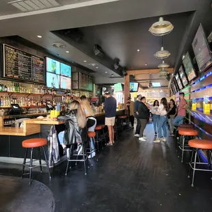 a group of people sitting at a bar